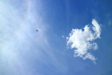 One airplane flying across the vibrant blue sky of Cusco region, Peru, South America