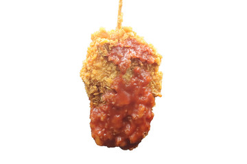 Crispy yellow fried chicken topped with tomato sauce, skewered
