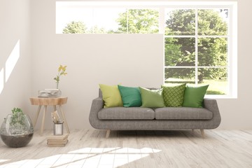 Stylish room in white color with sofa and summer landscape in window. Scandinavian interior design. 3D illustration