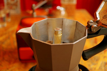 Boiling water running through the strainer of ground coffee creating a shot of espresso