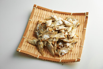 Dried fishes on bamboo sieve 