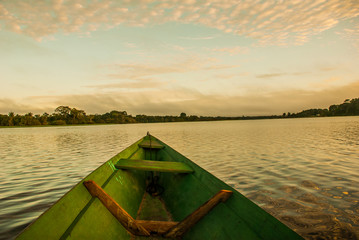 Beautiful sunrise on the river. View from the boat at Amazon river, with a dense forest on the...