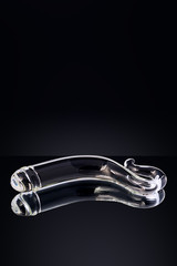 Clear colored Butt plug made of glass on a black background