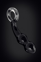 Clear colored Butt plug made of glass on a black background