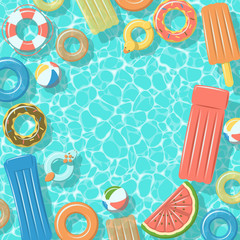 Swimming pool from top view with colorful inflatable rubber rings, rafts, beach ball and life buoy