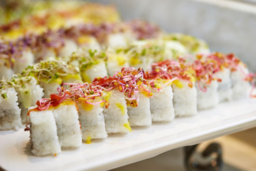 Sushi rolls and sprout on top 