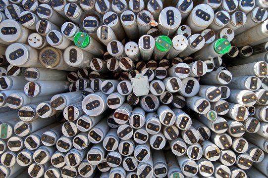 large amount of spent old fluorescent lamp tubes about to be recycled. Waste Disposal concept for old fluorescent lamp tubes. Ecology background or texture concept. 