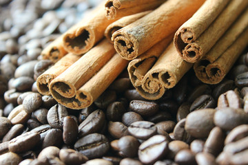 Cinnamon sticks and coffee beans closeup. Aromatic coffee - coffee beans and cinnamon sticks. Background. Copy space.