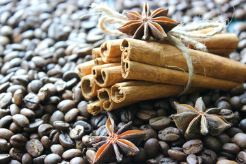 Cinnamon sticks and coffee beans closeup. Aromatic coffee - coffee beans and cinnamon sticks. Background. Copy space.