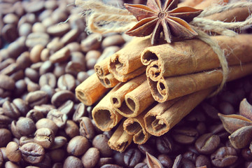 Cinnamon sticks and coffee beans closeup. Aromatic coffee - coffee beans and cinnamon sticks. Background. Copy space.
