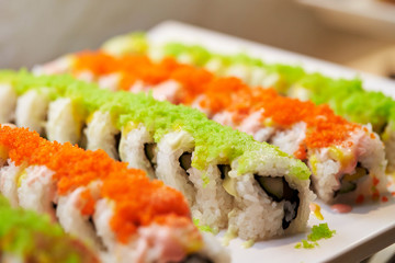 Sushi rolls with tobiko on top 