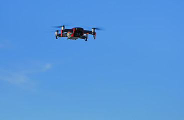 Fototapeta na wymiar Flying a red drone camera in the sky in Papagayo, Guanacaste, Costa Rica
