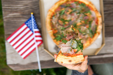 Celebrating Independence Day of America in the park with delicious pizza