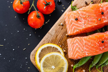 diet healthy food concept, raw fresh salmon fillet and ingredients on wooden background