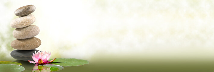 image of lotus and stones on water on green background