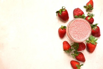 Strawberry smoothie in a tall glass. Top view with copy space.