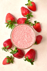 Strawberry smoothie in a tall glass. Top view with copy space.