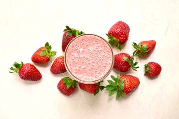 Strawberry smoothie in a tall glass. Top view with copy space.