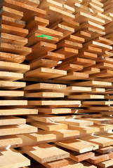 Wooden boards stacked neatly outside an industrial joinery