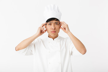 Excited asian chef wearing uniform standing