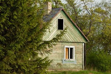 Fototapeta na wymiar Abandoned wooden house painted in green