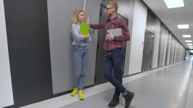 Young attractive colleagues flirting