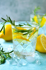 Summer citrus cocktail or lemonade with rosemary. Top view with copy space.