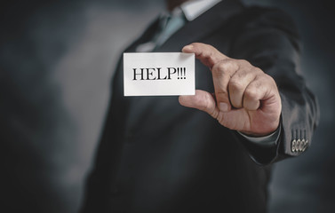 businessman holding a business card in his hand on a dark background