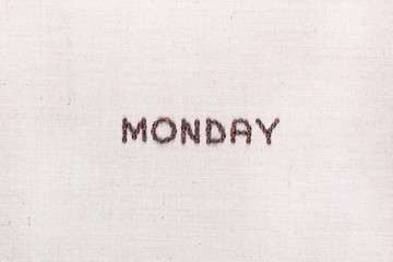 The word Monday written with coffee beans , aligned in the center.