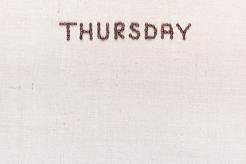 The word Thursday written with coffee beans , aligned at the top.