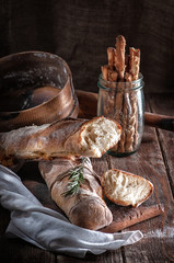bread, French bouquet with rosemary. on a wooden table