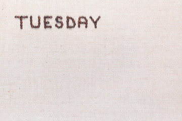 The word Tuesday written with coffee beans , aligned at the top left.