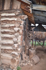 Vintage log and sod roof barn and farm equipment and tools