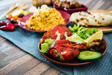 Traditional Indian food chicken tandoori and Tikka with garlic naan