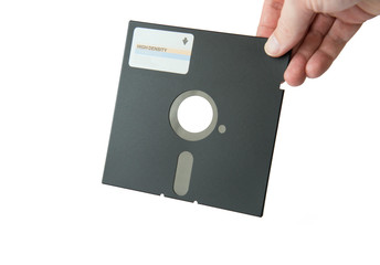 an isolated 5.25 floppy disk held by a hand