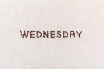 The word Wednesday written with coffee beans , aligned in the center.