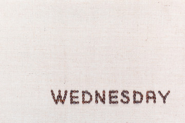 The word Wednesday written with coffee beans , aligned at the bottom right.
