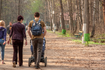 young parents with a baby stroller for a walk