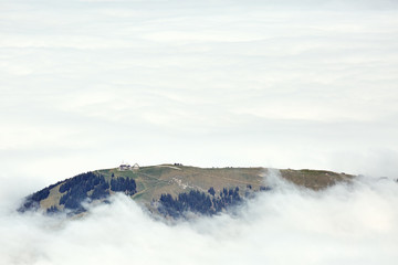 Mountain ridge peeps through the cloud cover