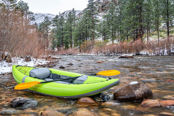 inflatable whitewater kayak in spring snowstorm