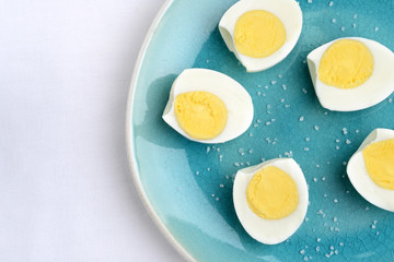 Fototapeta na wymiar closeup top view sliced eggs with salt