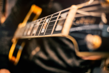 guitar and music string macro detail focus zone studio recording play hand concert closeup art guitarust rock electric color contrast melody harmony rhythm magic creation craft wood composer chord  - obrazy, fototapety, plakaty
