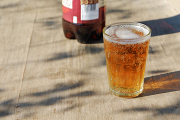 Pint glass of amber Pale Ale beer on a old wood table.