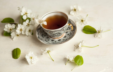 a cup of tea ,spring flowers,pear blossom,flat lay,white background