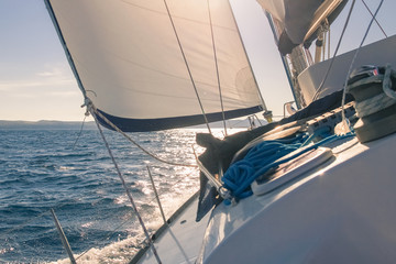 Sailing at sunset, white yacht and sea