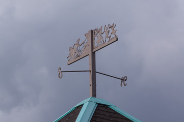 Ornamental compass sign on top of roof.