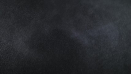 Aerosol Sprays Small Drops of Water on a Black Background. Slow Motion in 120 fps. Spray the liquid in the air. Micro drops of water fly in the air.