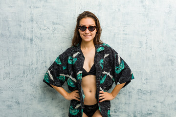 Young european woman wearing bikini confident keeping hands on her hips.