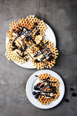 Waffles with chocolate, banana and berries.