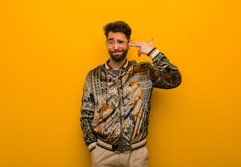 Young cool man doing a suicide gesture